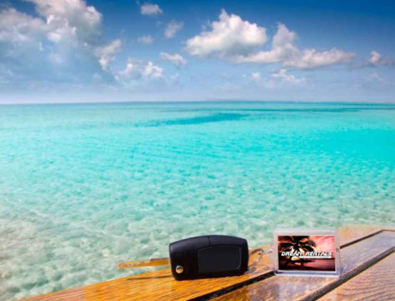car-keys-and-keychain-on-wooden-table-overlooking-caribbean-sea-with-logo car-keys-and-keychain-on-wooden-table-overlooking-caribbean-sea-with-logo
